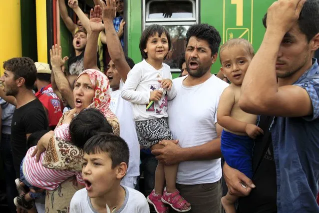 Migrants protest at the railway station in the town of Bicske, Hungary, September 3, 2015. Migrants threw themselves onto railway lines and scuffled with helmeted riot police trying to take them to a reception center in Hungary on Thursday, forced from a train in desperate scenes symbolic of a European asylum system brought to breaking point. (Photo by Bernadett Szabo/Reuters)