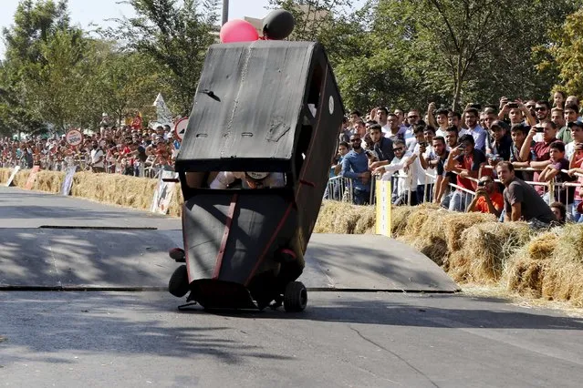 A competitor crashes while driving his homemade vehicle without an engine on a 300-metre-track during the Red Bull Soapbox Race in Amman, Jordan September 4, 2015. (Photo by Muhammad Hamed/Reuters)