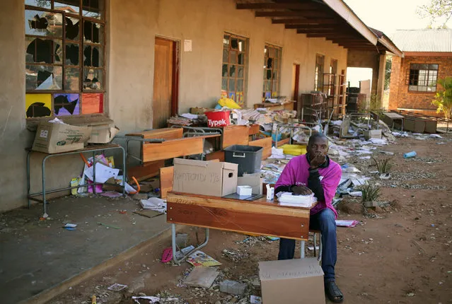 An IEC official waits for voters at a school which was damaged during riots in May, now used as a poling station during tense local municipal elections in Vuwani, South Africa's northern Limpopo province, August 3, 2016. (Photo by Siphiwe Sibeko/Reuters)