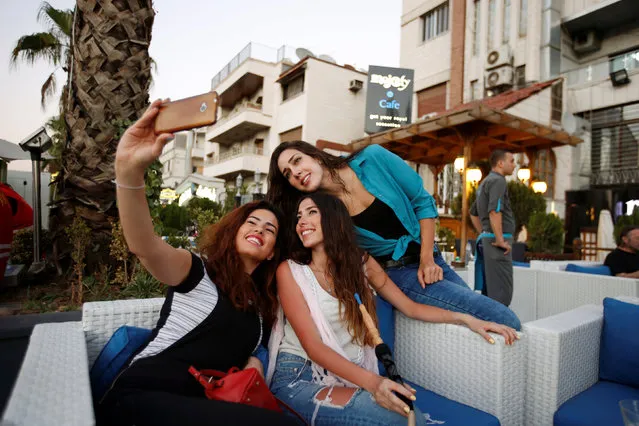 Syrian swimmer Baean Jouma (R) poses for a selfie with her friends at a cafe in Damascus, Syria July 27, 2016. (Photo by Omar Sanadiki/Reuters)