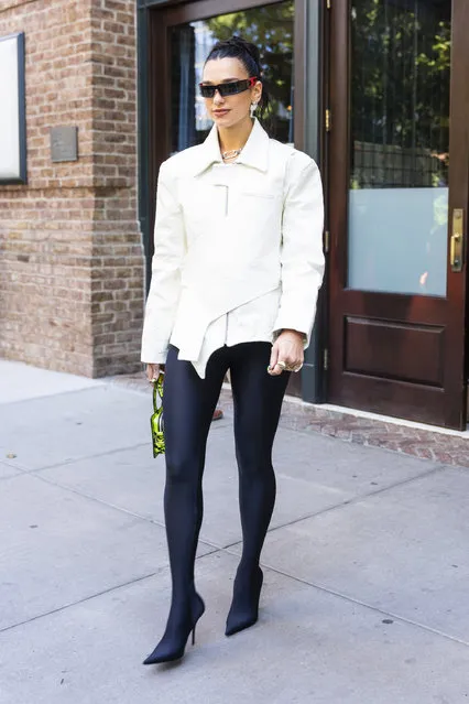 Dua Lipa is pictured leaving her hotel in New York City on September 27, 2022. The British singer wore a white jacket, black leggings, and stiletto heels. (Photo by The Image Direct)