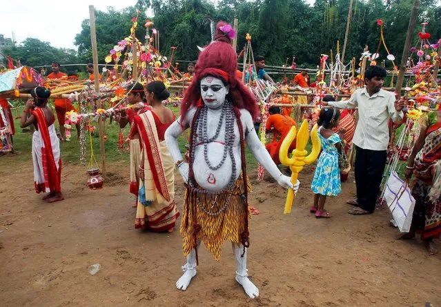 A Kanwariya or a Hindu devotee dressed as Lord Shiva takes part in a religious procession during the holy month of Shravan, in which devotees fast and worship Lord Shiva for the happiness of their families in Agartala, India, August 8, 2016. (Photo by Jayanta Dey/Reuters)
