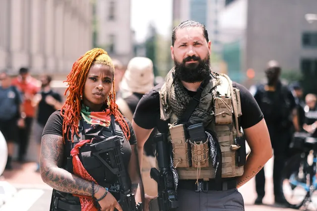 Two protesters carrying guns pose for photos during the open carry protest on July 4, 2020 in Richmond, Virginia. People attended an event in Virginia tagged Stand with Virginia, Support the 2nd amendment. (Photo by Eze Amos/Getty Images)