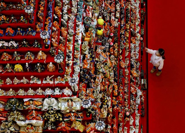 A girl looks at a showcase featuring 1,605 traditional Japanese dolls at an event celebrating Hinamatsuri, a traditional festival dedicated to the healthy growth of girls, in Konosu, Saitama Prefecture, Japan on March 3, 2025. (Photo by Kim Kyung-Hoon/Reuters)