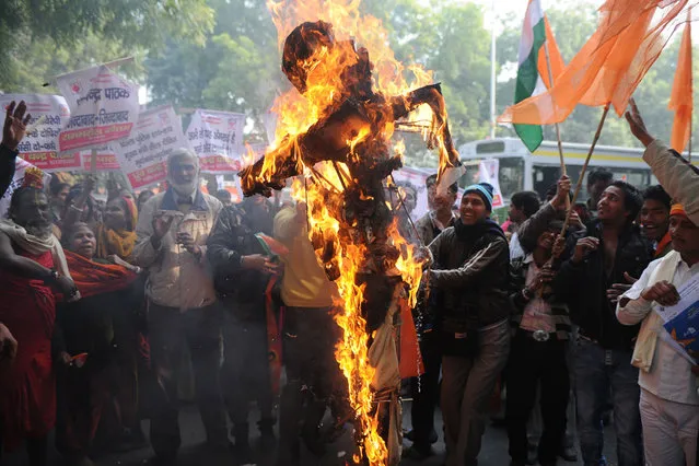 Indian demonstrators burn an effigy representing rapists during a protest calling for better safety for women following the rape of a student in New Delhi, on December 26, 2012. (Photo by Sajjad Hussain/AFP Photo)