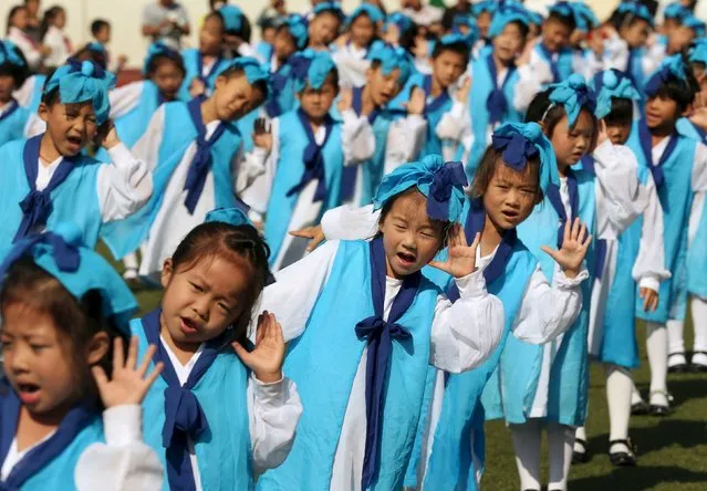 Grade-one children, wearing traditional costumes, attend an entrance ceremony in a primary school in Nantong, Jiangsu province, China, September 16, 2015. (Photo by Reuters/China Daily)