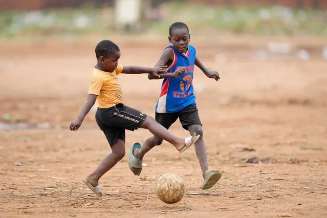 Children play soccer in an open space in Harare, Zimbabwe, Sunday, November 13, 2022. The World Cup begins this weekend in Qatar and the attention of the soccer world will be on the first Middle Eastern nation to host the tournament. But soccer is not only about watching the world's greatest players compete on the biggest stage. The sport transcends the elite level and is really the people's game. (Photo by Tsvangirayi Mukwazhi/AP Photo)