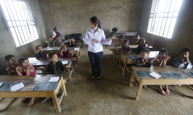 Giang Thi May teaches a first grade class at the primary school of Van Chai in Dong Van district, on the border with China, north of Hanoi, Vietnam, September 21, 2015. There is no electricity and no books. She teaches the children in the local Hmong language. (Photo by Reuters/Kham)