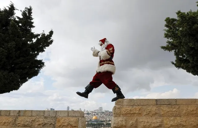 Issa Kassissieh walks in a Santa Claus costume during Christmas season on the Mount of Olives in Jerusalem on December 6, 2022. (Photo by Ammar Awad/Reuters)