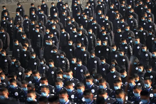 People stand during a silent tribute during a ceremony at the Memorial Hall of the Victims in Nanjing Massacre by Japanese Invaders on the annual national day of remembrance to commemorate the 85th anniversary of the Nanjing massacre in Nanjing, in China's eastern Jiangsu province on December 13, 2022. (Photo by CNS/AFP Photo)