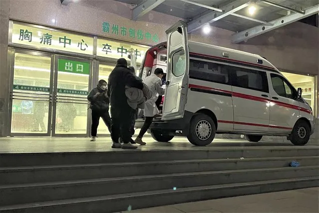 An ambulance prepares to transfer a patient in critical care to other hospitals due to overcapacity at the emergency department of the Langfang No. 4 People's Hospital in Bazhou city in northern China's Hebei province on Thursday, December 22, 2022. As China grapples with its first-ever wave of COVID mass infections, emergency wards in the towns and cities to Beijing's southwest are overwhelmed. Intensive care units are turning away ambulances, residents are driving sick relatives from hospital to hospital, and patients are lying on floors for a lack of space. (Photo by AP Photo/Stringer)