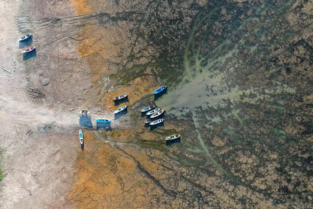 A drone photo shows an aerial view of boats and Lake Marmara as water level dropped to 1.5 percent due to irrigation for agriculture and hot weather of summer season in the area between Salihli district and Golmarmara district in Manisa province of Turkey on September 08, 2020. The water level in Lake Marmara, which provides annually an average of 150 million cubic meters of water to the Gediz Plain, has dramatically dropped and it is estimated that 20 million cubic meters of water left. The depth in the lake decreased to 50 centimeters. Falling Lake Marmara water level, also negatively affected the residents of the neighborhood who make a living by fishing. (Photo by Ahmet Bayram/Anadolu Agency via Getty Images)