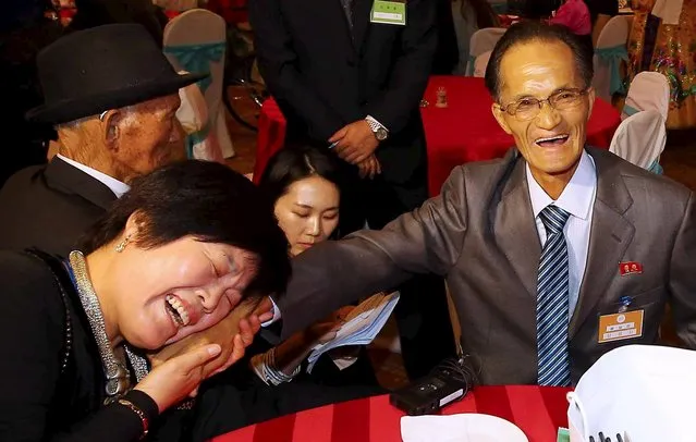 South Korean Bae Sun-ok (L) meets with her North Korean brother Bae Sang Man during the separated family reunions at Mount Kumgang resort, North Korea, October 24, 2015. Nearly 400 South Koreans crossed the heavily armed border into North Korea on Tuesday full of joyful anticipation at reuniting with family members separated for more than six decades since the 1950-53 Korean War. (Photo by Reuters/Yonhap)