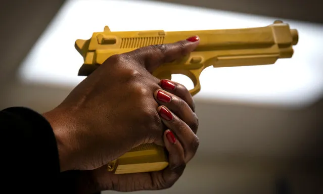 Andreyah Garland, a 44-year-old single mother of three daughters and member of the Hudson Valley Nubian Gun Club, points a training pistol during a gun training session in Newburgh, New York, U.S., October 13, 2020. (Photo by Mike Segar/Reuters)