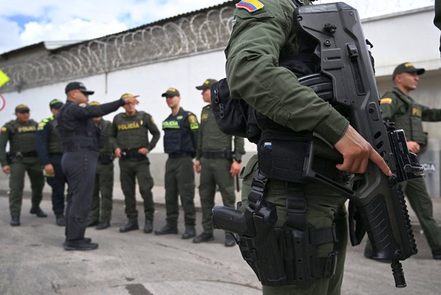 A heavily armored police officer patrols the surroundings of La Modelo prision in Bogota on May 17, 2024. The director of La Modelo prison, one of Colombia's main penitentiaries, was shot dead on May 16 in Bogota after receiving several death threats, the government said. (Photo by Raul Arboleda/AFP Photo)