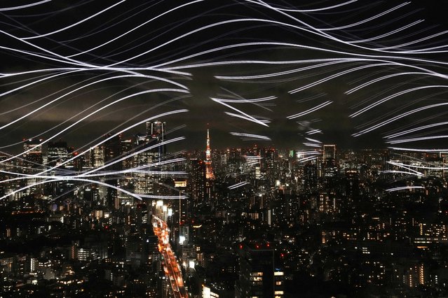 The image of a nebula is seen reflected on a window at the Sky Gallery, an observation deck at Shibuya Scramble Square, a tourist spot that offers a panoramic view of Tokyo, on July 16, 2025. The observation facility, Sky Galley, is hosting a special limited-time event until August 31, inspired by nebulae that can be enjoyed indoors in the middle of summer. (Photo by Kazuhiro Nogi/AFP Photo)