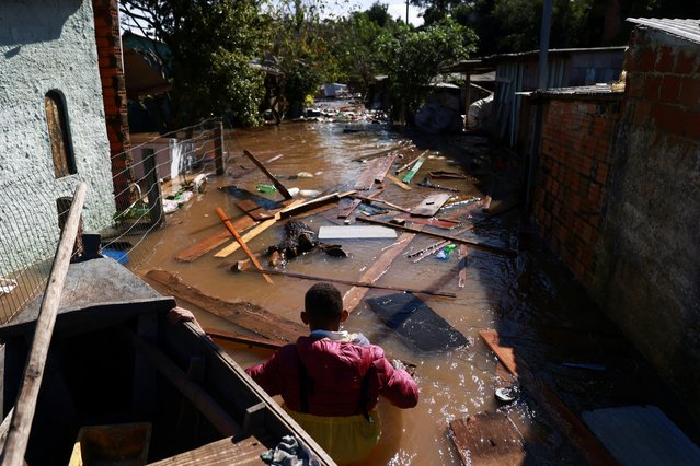 Valderci Trindade, 24,  who lost his house tries to save useful items in a flooded area due to heavy rains, in Serraria in Porto Alegre, Rio Grande do Sul, Brazil, on May 14, 2024. (Photo by Diego Vara/Reuters)