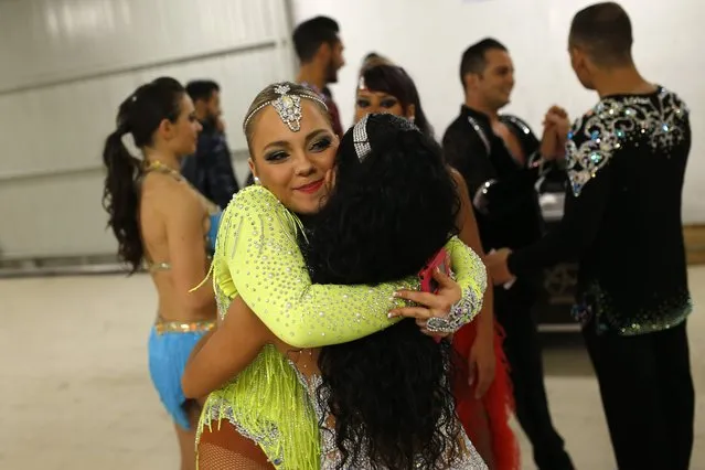 In this Friday, November 6, 2015 photo Spanish dancer Maria Garrido, left, congrats Alba Ibanez, also from Spain, after Ibanez won with her partner Luis Chavez, rear second right, the World Salsa Master dance competition in Madrid. (Photo by Francisco Seco/AP Photo)
