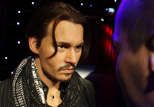 A man looks at a wax figure of actor Johnny Depp at the opening of Madame Tussauds in Vienna March 31, 2011. (Photo by Herwig Prammer/Reuters)