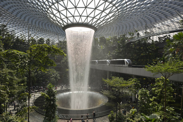 Rain Vortex is the waterfall at Jewel Changi that is known as the world's largest indoor waterfall and stands at a height of 40 meters at Jewel Changi Airport in Singapore, Monday, June 3, 2024. (Photo by Vincent Thian/AP Photo)
