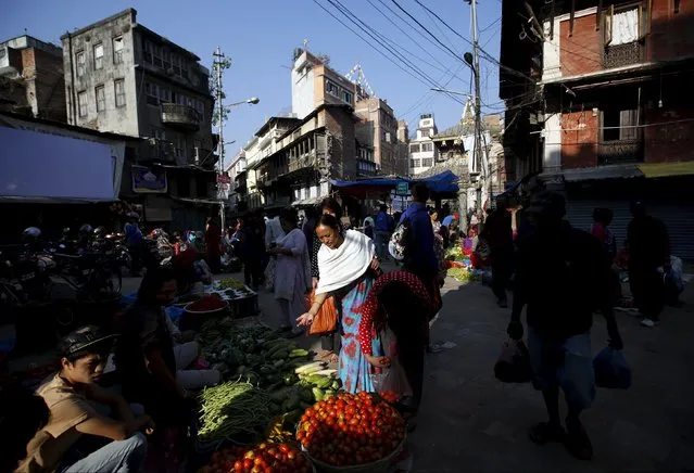 A woman (C) buys vegetables along the streets of Kathmandu, Nepal October 6, 2015. (Photo by Navesh Chitrakar/Reuters)