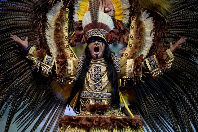 A reveller of the Boi Caprichoso Association performs during the annual Parintins folklore festival at the Bumbodromo in Parintins, Amazonas state, Brazil on June 28, 2024. (Photo by Bruno Kelly/Reuters)