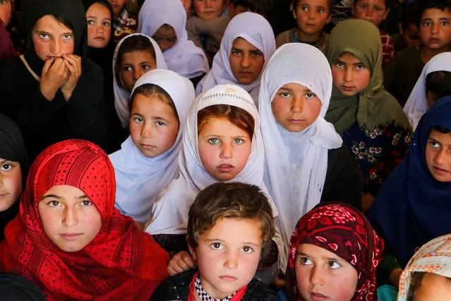 Afghan children attend a class at an open air school on the outskirts of Fayzabad district, Badakhshan province on March 27, 2023. (Photo by Omer Abrar/AFP Photo)
