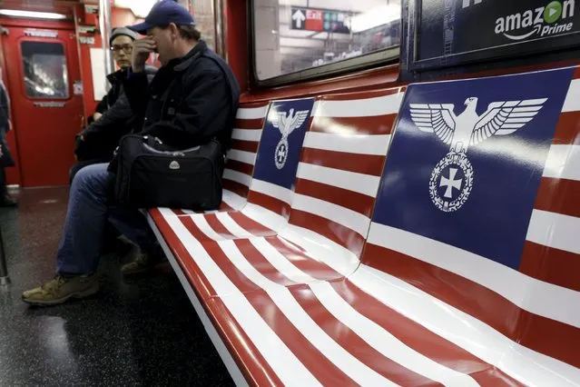 Passengers ride a 42nd Street Shuttle subway train, wrapped with advertising for the Amazon series "The Man in the High Castle", in the Manhattan borough of New York, November 24, 2015. New York City Mayor Bill de Blasio on Tuesday called on Amazon.com Inc to remove "irresponsible and offensive" subway advertisements for a new television show featuring Nazi-inspired imagery. (Photo by Brendan McDermid/Reuters)
