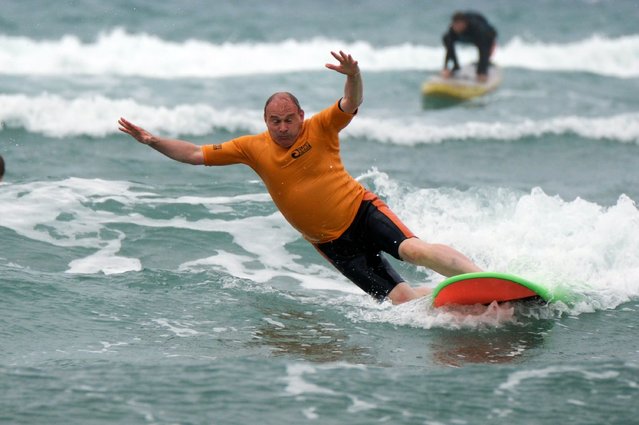 Liberal Democrat leader Sir Ed Davey falls from a surfboard during a visit to Big Blue Surf School in Bude in Cornwall, while on the General Election campaign trail on Tuesday, July 2, 2024. (Photo by Matt Keeble/PA Images via Getty Images)