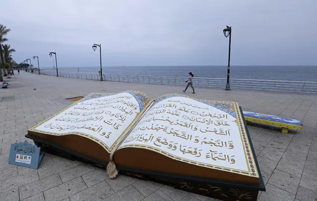 A large representation of the Quran, Islam's holy book, is displayed on the  Mediterranean seafront promenade, during the Islamic holy month of Ramadan, in Beirut, Lebanon, Monday, May 28, 2018. (Photo by Hassan Ammar/AP Photo)