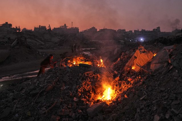 Palestinians in Gaza City light fires to keep away mosquitoes on Monday, November 10, 2025. Much of the city has been destroyed by Israeli bombardments since the October 7, 2023 attacks on Israel by Hamas. (Photo by Jehad Alshrafi/AP Photo)