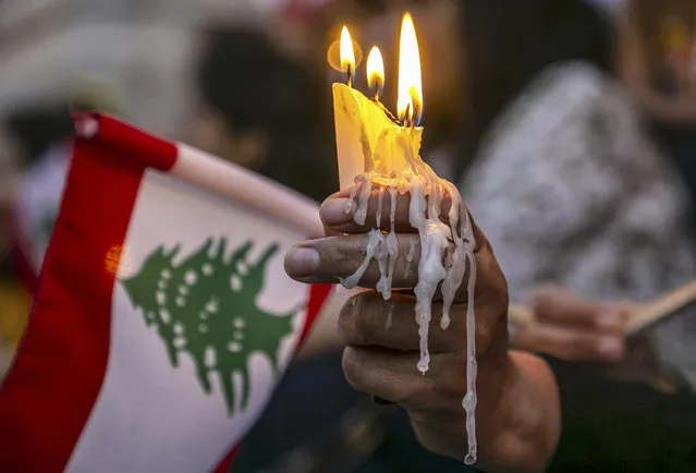 Tunisians light a candle during a demonstration in support of Lebanese people following the explosion in the port of Beirut, on August 06, 2020 in Tunis, Tunisia. (Photo by Yassine Gaidi/Anadolu Agency via Getty Images)
