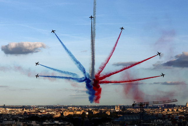 The Patrouille de France, an aerobatics demonstration unit of the French Air Force, trail smoke as they fly over Paris during a parade for French athletes who participated in the 2024 Olympics and Paralympics, Saturday, September 14, 2024 in Paris.(Photo by Gonzalo Fuentes/Pool Photo via AP Photo)