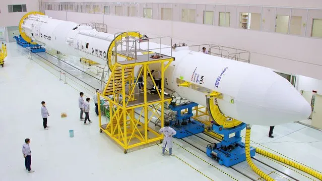 A handout photo made available by Korea Aerospace Research Institute shows the country's first homegrown space rocket, Nuri, being assembled at the Naro Space Center in Goheung, South Korea, 16 May 2023 (issued 17 May 2023), eight days ahead of its third launch. (Photo by Korea Aerospace Research Institute/EPA)