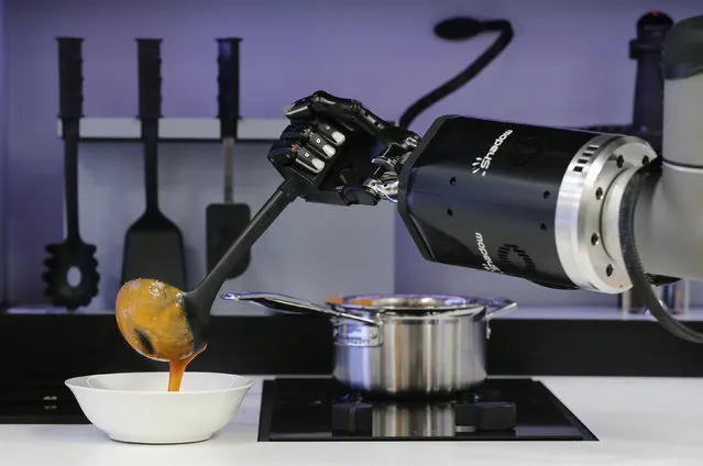 A robot in the Robotic Kitchen prototype created by Moley Robotics cooks a crab soup at the company's booth at the world's largest industrial technology fair, the Hannover Messe, in Hanover, Germany April 13, 2015. (Photo by Wolfgang Rattay/Reuters)