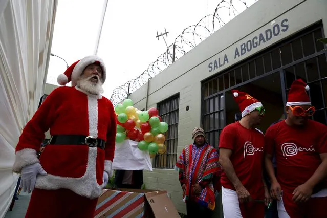 A Spanish inmate dressed as Santa Claus takes part in a Christmas event at Sarita Colonia male prison in Callao, Peru, December 18, 2015. (Photo by Mariana Bazo/Reuters)