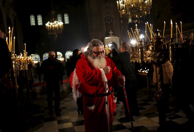 A man dressed as Santa Claus attends a Christmas mass at Alexander Nevski cathedral in Sofia, Bulgaria December 25, 2015. (Photo by Stoyan Nenov/Reuters)
