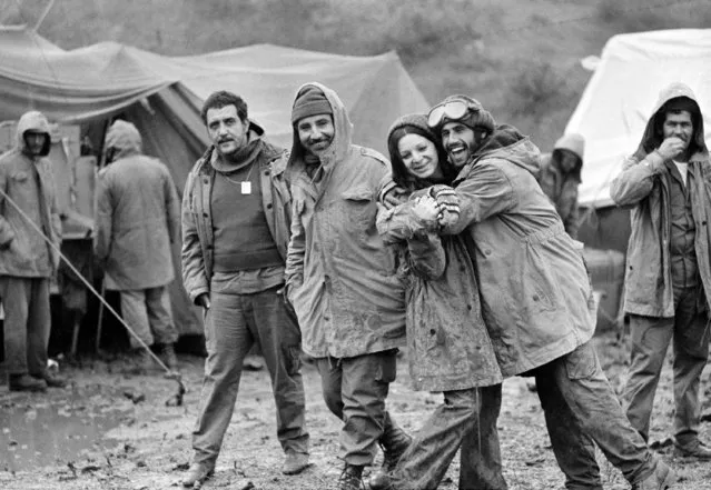 Israeli soldiers at the Syrian cease-fire line in the Golan Heights are seen, October 31, 1973, after sudden cold, rain and fog hit them.  Female soldier is radio operator Zehava Mizrachi. Other soldiers are unidentified. (Photo by AP Photo)