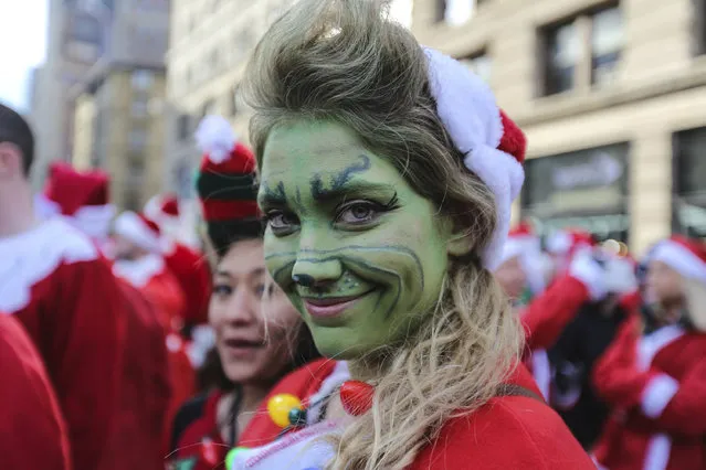 Revellers dressed up as Santa Claus take part in the annual Santacon festival at Times square in New York, United States on December 10, 2016. Santacon began in San Francisco in 1994, inspired by a Mother Jones article on the Danish activist theatre group Solvognen. (Photo by Vanessa Carvalho/Brazil Photo Press/Getty Images)