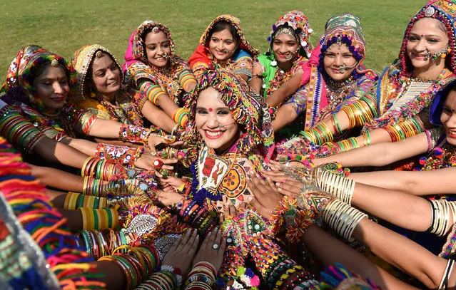 Abha Shah (C) Choreographer of Surtaal Performing Arts, poses along with her group members as they participate in a “Garba” dance rehearsal ahead of the forthcoming “Navratri” festival on the outskirts of Ahmedabad on October 7, 2018. “Navratri” or dance festival of nine nights begins October 10 and culminates with the celebration of “Dussehra”. (Photo by Sam Panthaky/AFP Photo)