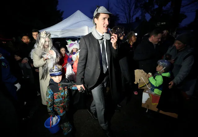 Canada's Prime Minister Justin Trudeau walks with his son Hadrien while participating in Halloween festivities with his family at Rideau Hall in Ottawa, Ontario, Canada October 31, 2018. (Photo by Chris Wattie/Reuters)