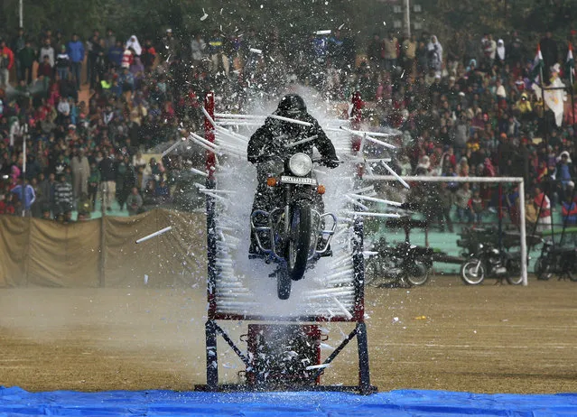 An Indian policeman performs a stunt on his motorcycle during the Republic Day parade in Jammu, India January 26 2016. (Photo by Mukesh Gupta/Reuters)