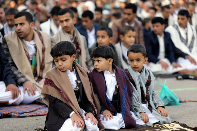 Boys perform the Eid al-Fitr prayers marking the end of the fasting month of Ramadan in Sanaa, Yemen on May 13, 2021. (Photo by Khaled Abdullah/Reuters)