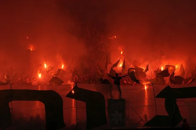 Maccabi fans burn torches before the UEFA Europe League match between Panathinaikos and Maccabi Haifa in Haifa, Israel, Thursday, October 5, 2023. (Photo by Ohad Zwigenberg/AP Photo)