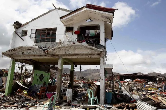 Survivors stay in their damaged house in Tacloban city. (Photo by Romeo Ranoco/Reuters)