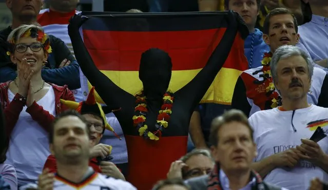 A masked supporter of Germany holds up German flag during their Men's European Handball Championship final match against Spain in Krakow, Poland, January 31, 2016. (Photo by Kacper Pempel/Reuters)