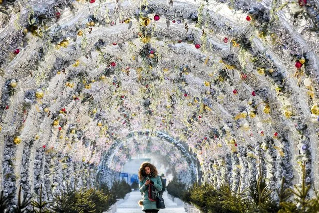 A woman walks in the tunnel decorated with festive lights for the upcoming holidays in central Moscow, Russia on December 17, 2018. (Photo by Kirill Kudryavtsev/AFP Photo)