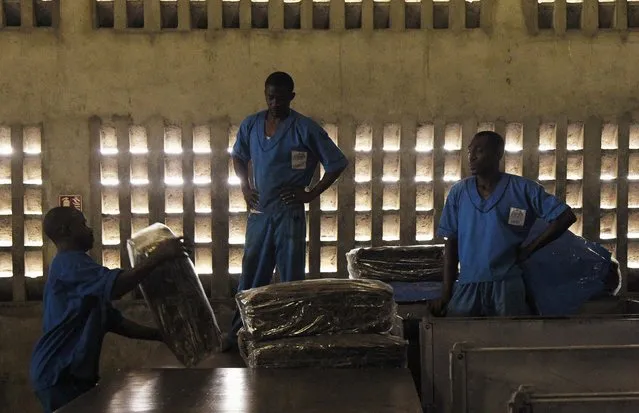 Men work at a rubber factory in Songon village, north of Abidjan January 25, 2016. (Photo by Luc Gnago/Reuters)