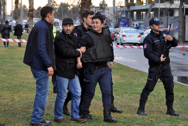 This photo obtained from the photo agency Depo Photos shows a police officer (C) crying and reacting while being evacuated after a colleague was killed at the site of an explosion in front of the courthouse in Izmir on January 5, 2017. A police officer and a court worker were killed when a car bomb exploded outside a courthouse in the western Turkish city of Izmir on January 5, 2017, state- run news agency reported. At least 11 people were wounded, Dogan news agency reported, after the blast outside the prosecutors and judges' entrance in the usually peaceful city on the Aegean Sea. (Photo by AFP Photo/Depo Photos)