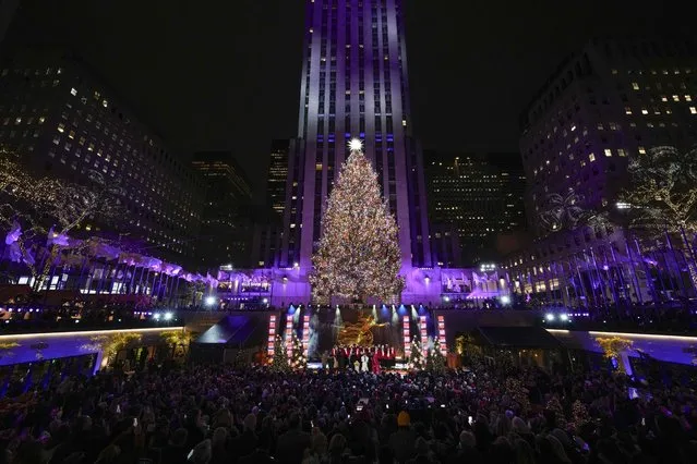 The Christmas tree at Rockefeller Center is lit in New York, Wednesday, November 29, 2023. (Photo by Seth Wenig/AP Photo)